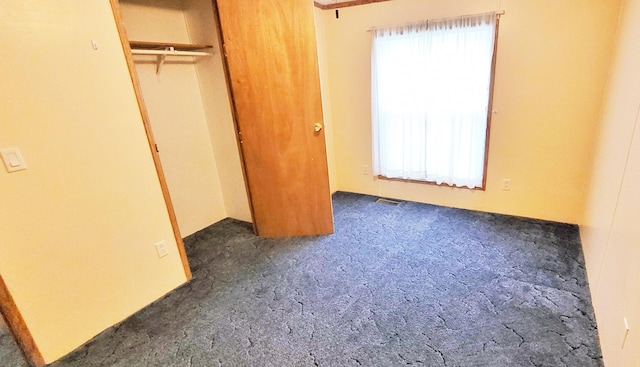 8326 S Delaware Ave, Baldwin, MI 49304 - unfurnished bedroom featuring carpet flooring and a closet