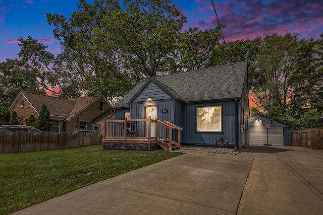 123 Oneida St SW, Wyoming, MI 49548 - view of front facade featuring a garage, board and batten siding, an outdoor structure, and a shingled roof