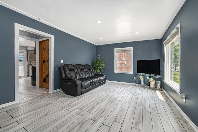 123 Oneida St SW, Wyoming, MI 49548 - living room featuring wood finished floors, baseboards, ornamental molding, and recessed lighting