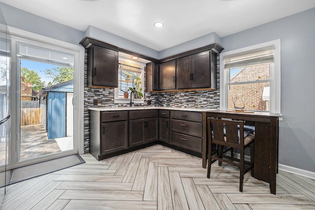 123 Oneida St SW, Wyoming, MI 49548 - bar with plenty of natural light, decorative backsplash, baseboards, recessed lighting, and a sink