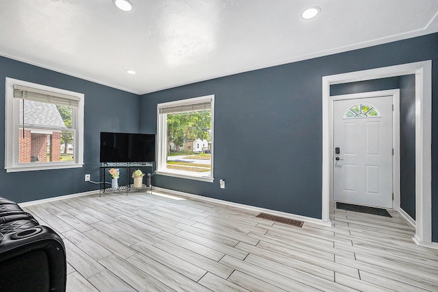 123 Oneida St SW, Wyoming, MI 49548 - unfurnished living room featuring wood finish floors, baseboards, and recessed lighting