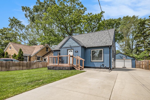 123 Oneida St SW, Wyoming, MI 49548 - view of front facade featuring a detached garage, an outbuilding, board and batten siding, and roof with shingles