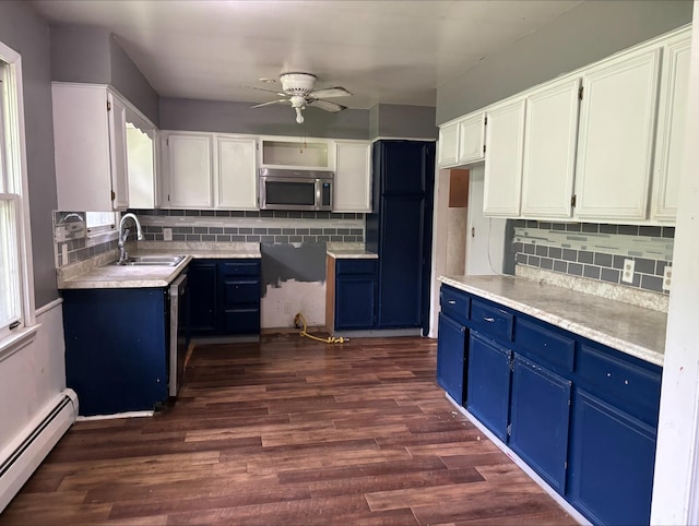 1965 E Kimmel Rd, Jackson, MI 49201 - kitchen featuring a baseboard heating unit, blue cabinets, stainless steel microwave, ceiling fan, and a sink