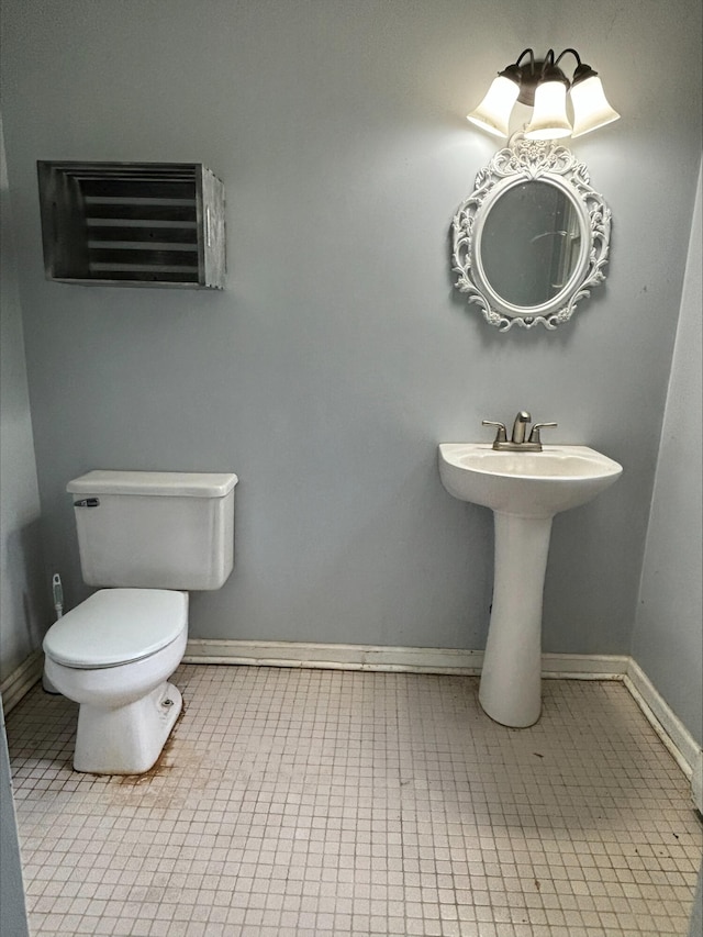 1965 E Kimmel Rd, Jackson, MI 49201 - bathroom featuring toilet, baseboards, and tile patterned floors