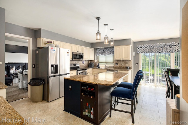 47951 Picadilly Ct, Canton, MI 48187 - kitchen with appliances with stainless steel finishes, tasteful backsplash, cream cabinets, and a center island