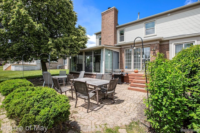 47951 Picadilly Ct, Canton, MI 48187 - view of patio / terrace with a sunroom, area for grilling, and outdoor dining space