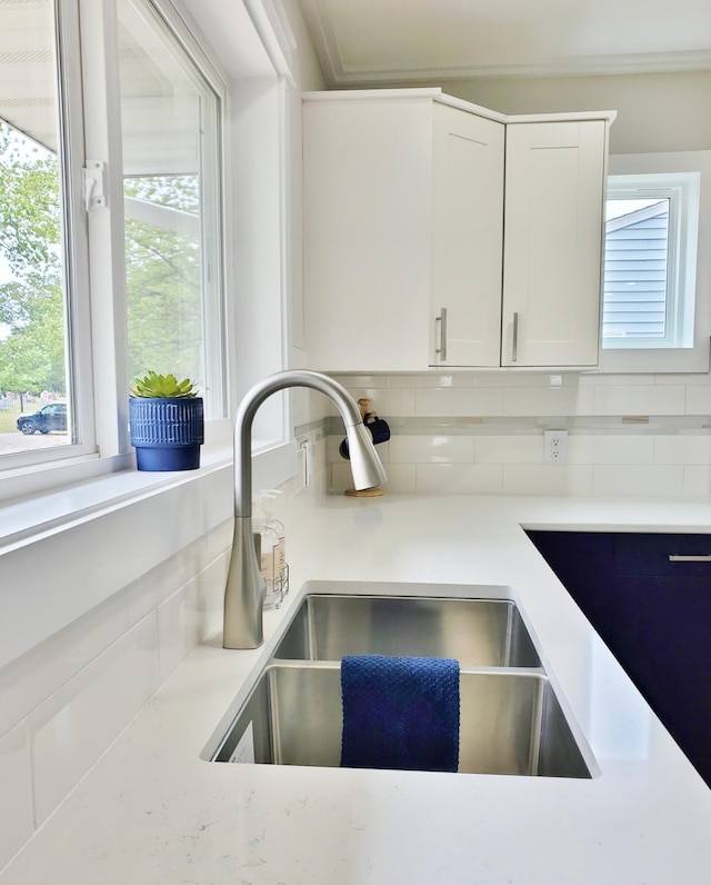 121 S Marshall St, New Buffalo, MI 49117 - kitchen view of a sink, tasteful backsplash, light countertops, and white cabinetry