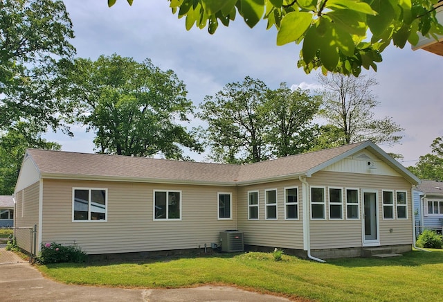 121 S Marshall St, New Buffalo, MI 49117 - rear view of property with central air condition unit, a lawn, and roof with shingles