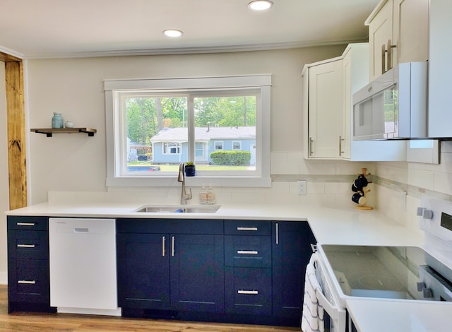 121 S Marshall St, New Buffalo, MI 49117 - kitchen featuring white appliances, a sink, blue cabinetry, white cabinetry, and recessed lighting