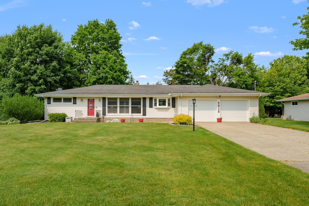 6028 Cypress St, Portage, MI 49024 - view of front facade with an attached garage, driveway, and a front yard
