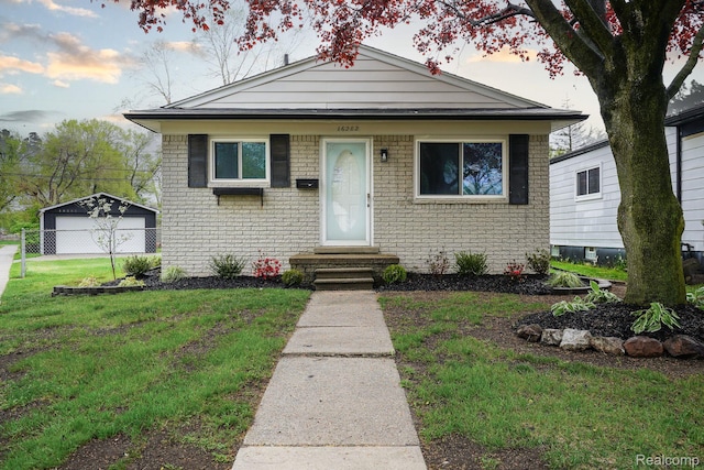 16282 Evergreen Ave, Eastpointe, MI 48021 - bungalow-style home featuring entry steps, brick siding, and a detached garage
