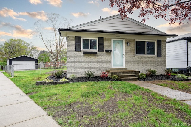 16282 Evergreen Ave, Eastpointe, MI 48021 - bungalow-style home with a garage, brick siding, and entry steps