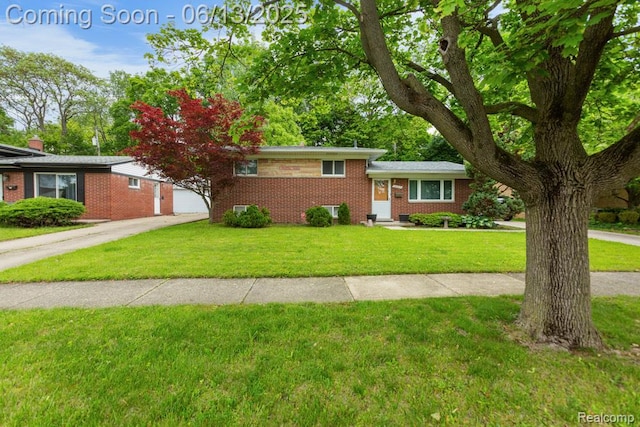 32702 Winona St, Westland, MI 48185 - split level home featuring brick siding, a front lawn, and concrete driveway