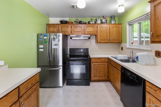32702 Winona St, Westland, MI 48185 - kitchen with black appliances, under cabinet range hood, light countertops, and brown cabinets
