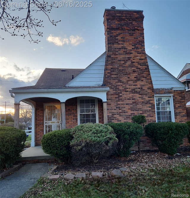 10505 Somerset Ave, Detroit, MI 48224 - view of side of property with a chimney and covered porch
