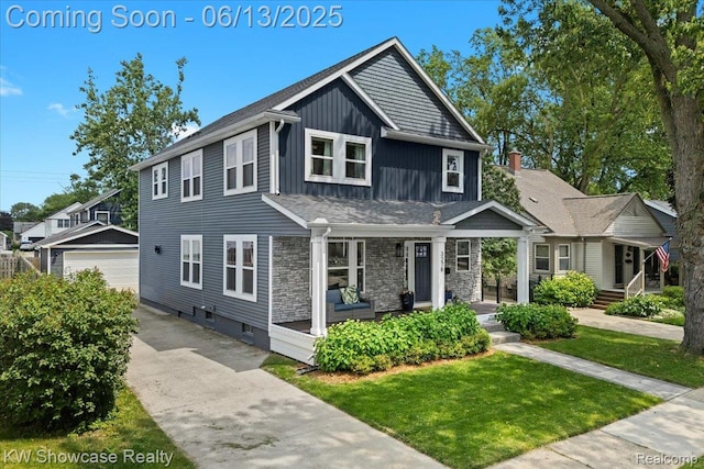 3278 Tyler Ave, Berkley, MI 48072 - view of front of property featuring a porch, an outbuilding, board and batten siding, a front lawn, and a detached garage
