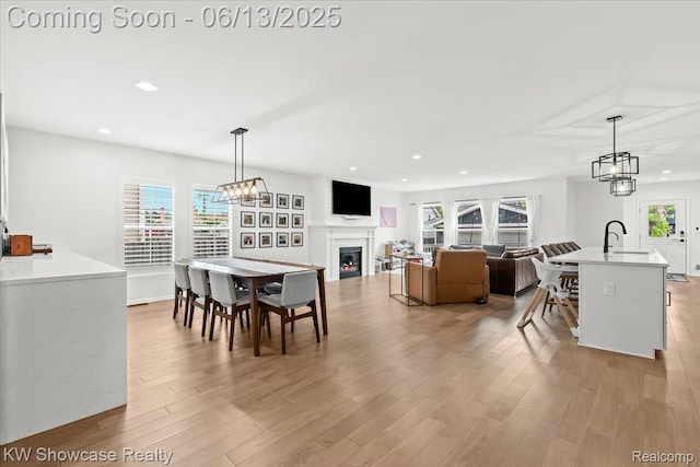 3278 Tyler Ave, Berkley, MI 48072 - dining area featuring recessed lighting, a warm lit fireplace, and light wood-type flooring