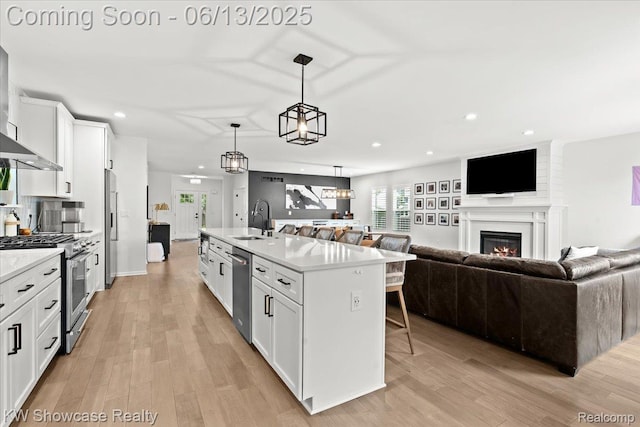 3278 Tyler Ave, Berkley, MI 48072 - kitchen featuring open floor plan, premium appliances, a kitchen breakfast bar, white cabinets, and light countertops