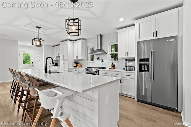 3278 Tyler Ave, Berkley, MI 48072 - kitchen with high end appliances, wall chimney range hood, recessed lighting, white cabinetry, and decorative backsplash