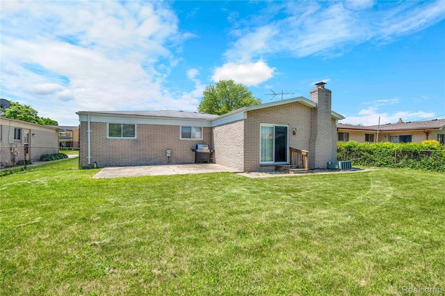 37288 Vernon Dr, Sterling Heights, MI 48310 - back of property with brick siding, a patio area, a chimney, a yard, and entry steps