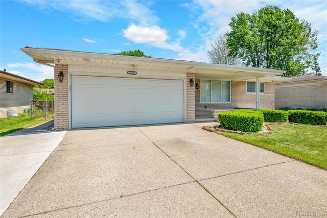 37288 Vernon Dr, Sterling Heights, MI 48310 - ranch-style house featuring brick siding, driveway, and a garage