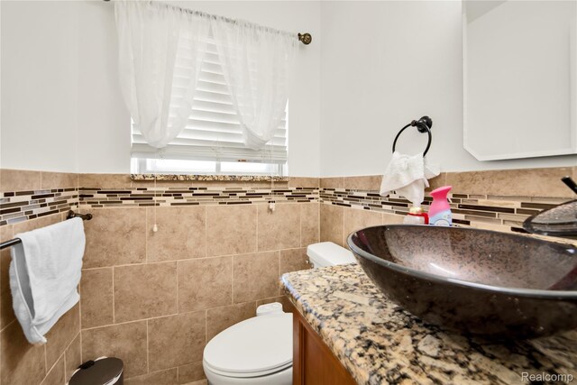 37288 Vernon Dr, Sterling Heights, MI 48310 - half bath with tile walls, vanity, toilet, and wainscoting