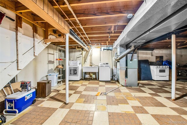 37288 Vernon Dr, Sterling Heights, MI 48310 - unfinished below grade area featuring tile patterned floors, a sink, washing machine and dryer, and heating unit