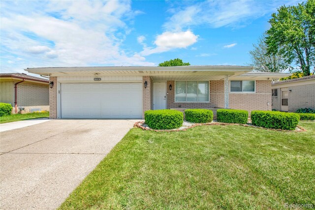 37288 Vernon Dr, Sterling Heights, MI 48310 - view of front facade with brick siding, concrete driveway, a garage, and a front yard