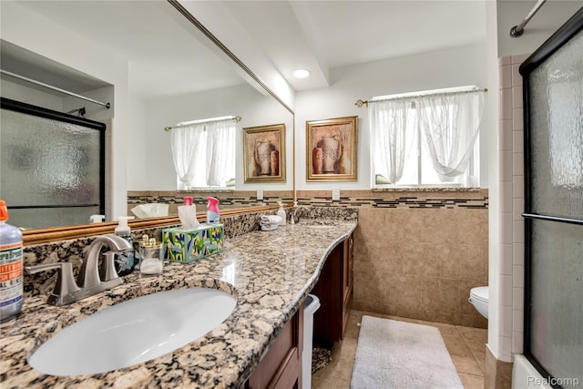 37288 Vernon Dr, Sterling Heights, MI 48310 - full bath with tile patterned floors, a shower with door, double vanity, tile walls, and toilet