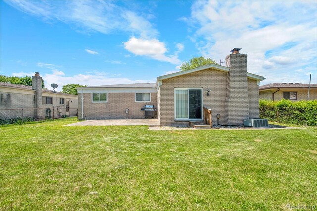 37288 Vernon Dr, Sterling Heights, MI 48310 - rear view of property with a chimney, a patio area, brick siding, central AC unit, and entry steps
