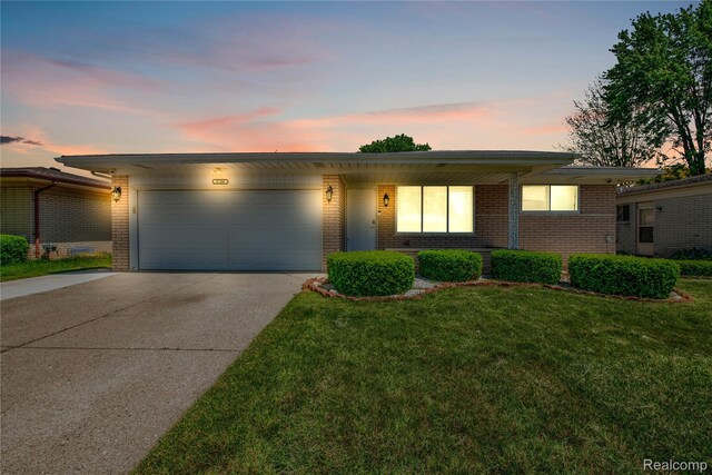 37288 Vernon Dr, Sterling Heights, MI 48310 - view of front facade featuring brick siding, driveway, a garage, and a front yard