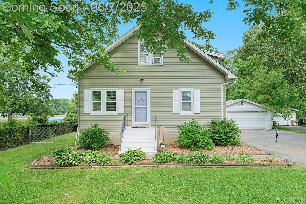 4019 N Belsay Rd, Flint, MI 48506 - bungalow featuring an outdoor structure and a detached garage