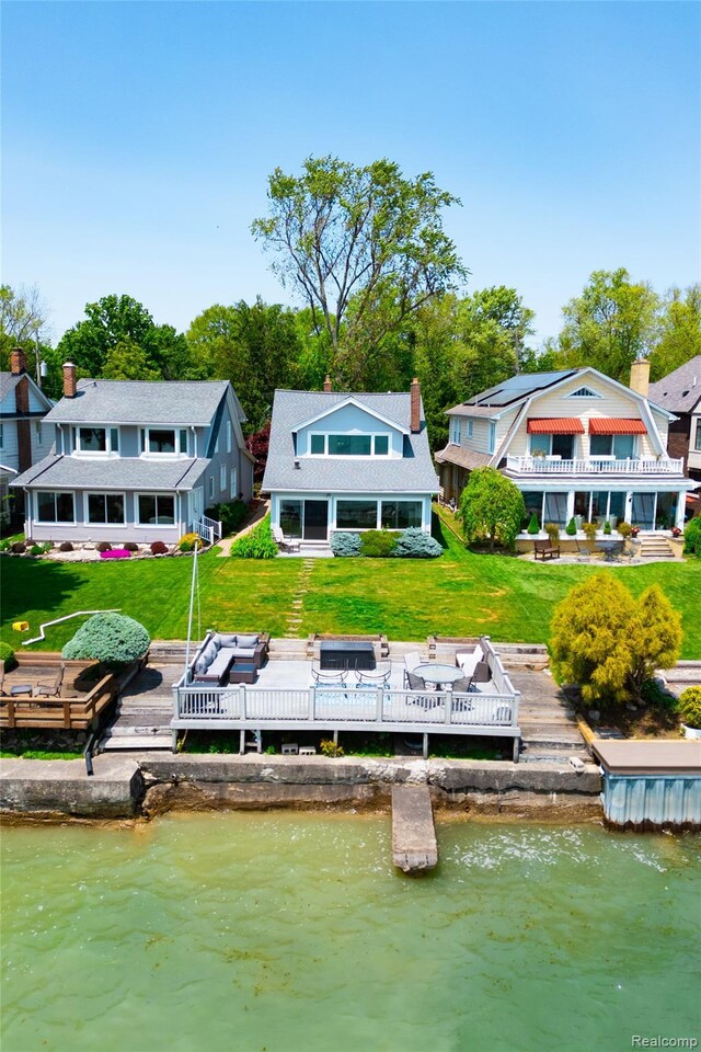29899 E River Rd, Grosse Ile, MI 48138 - back of property featuring a yard and a deck with water view