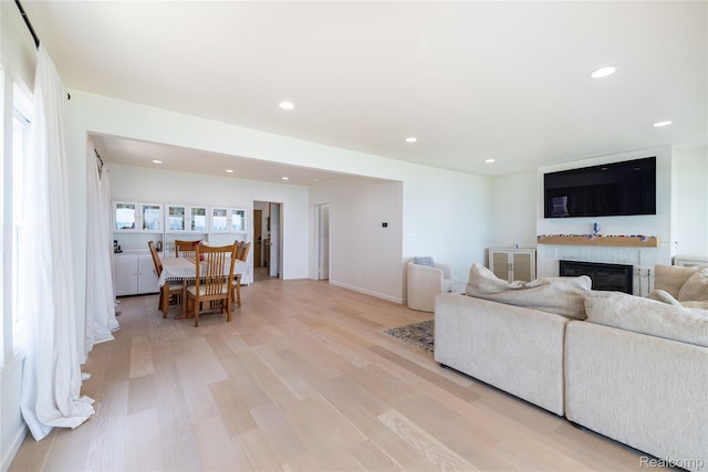 29899 E River Rd, Grosse Ile, MI 48138 - living room with light wood-type flooring, a glass covered fireplace, recessed lighting, and baseboards