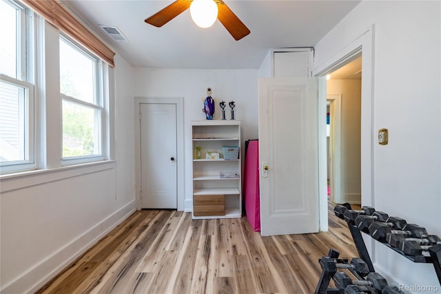 29899 E River Rd, Grosse Ile, MI 48138 - bedroom with light wood finished floors and a ceiling fan