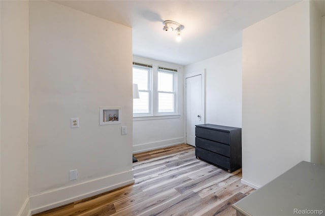 29899 E River Rd, Grosse Ile, MI 48138 - washroom featuring light wood-style flooring, washer hookup, and baseboards