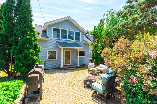 29899 E River Rd, Grosse Ile, MI 48138 - traditional-style house featuring a patio area, roof with shingles, and an outdoor hangout area