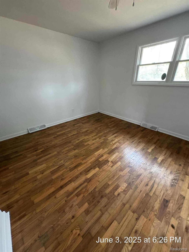 7025 Coldwater Rd, Flushing, MI 48433 - empty room featuring dark wood-style floors and baseboards