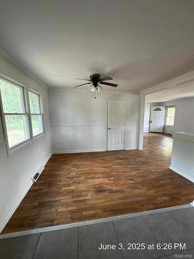 7025 Coldwater Rd, Flushing, MI 48433 - empty room with wood finished floors, a ceiling fan, and crown molding