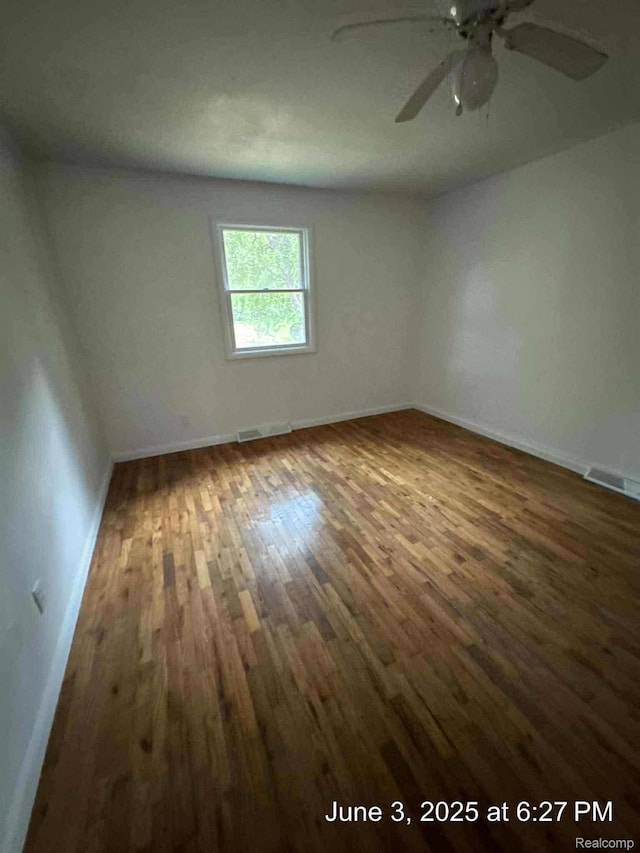7025 Coldwater Rd, Flushing, MI 48433 - empty room with wood finished floors, a ceiling fan, and baseboards