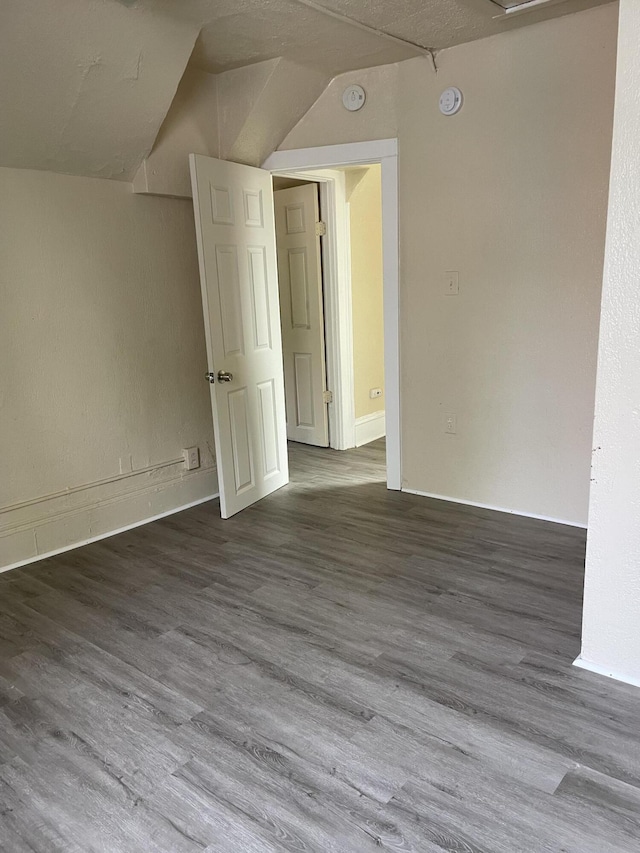 1122 Prospect St, Lansing, MI 48912 - unfurnished room featuring wood finished floors and lofted ceiling