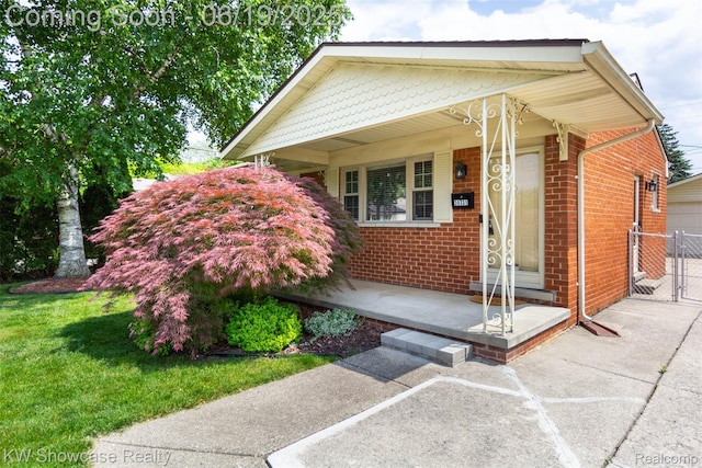 30731 Middlebury St, Westland, MI 48186 - view of front of house featuring brick siding, covered porch, and a gate