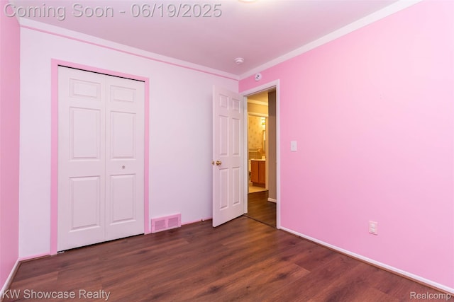 30731 Middlebury St, Westland, MI 48186 - unfurnished bedroom with dark wood-style floors, a closet, and crown molding