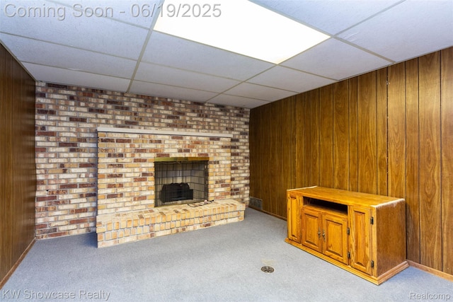 30731 Middlebury St, Westland, MI 48186 - unfurnished living room featuring wood walls, carpet, a drop ceiling, and a brick fireplace