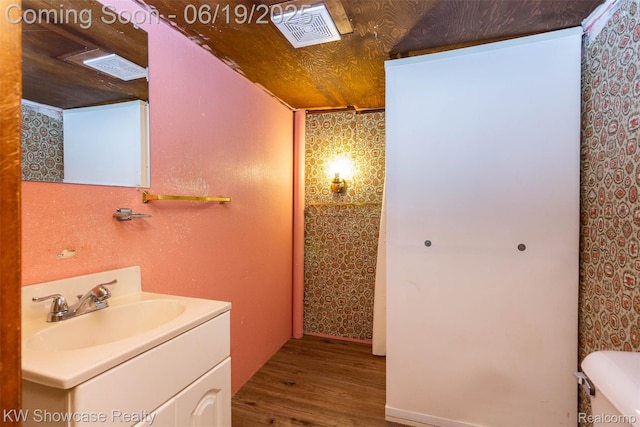 30731 Middlebury St, Westland, MI 48186 - bathroom with wood finished floors, vanity, and wallpapered walls