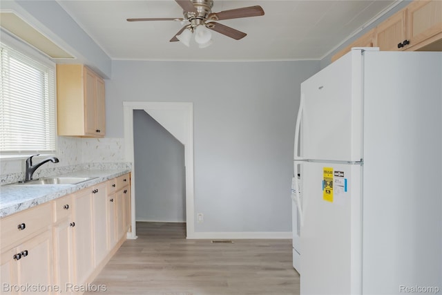23123 Lambrecht Ave, Eastpointe, MI 48021 - kitchen with freestanding refrigerator, light brown cabinets, a sink, ceiling fan, and light wood finished floors