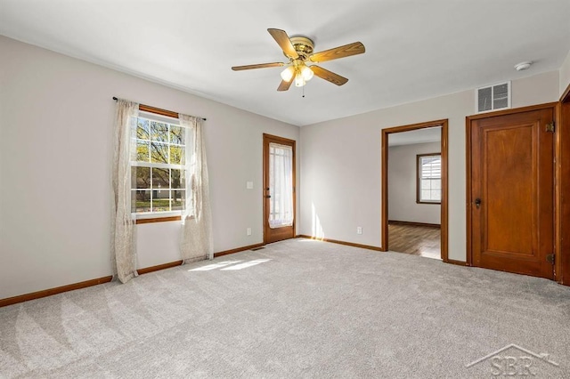 5200 Swede Ave, Midland, MI 48640 - empty room with a ceiling fan, light carpet, and baseboards