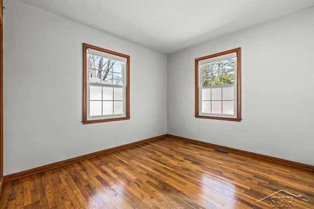 5200 Swede Ave, Midland, MI 48640 - spare room with healthy amount of natural light, hardwood / wood-style floors, and baseboards