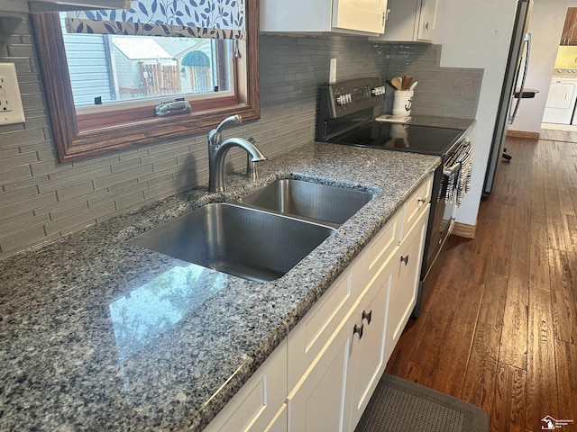 3117 Morin Point St, Erie, MI 48133 - kitchen featuring a sink, black / electric stove, backsplash, and white cabinets