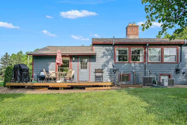 2845 Pittsfield Blvd, Ann Arbor, MI 48104 - rear view of house featuring a yard, a wooden deck, a chimney, central AC unit, and a shingled roof